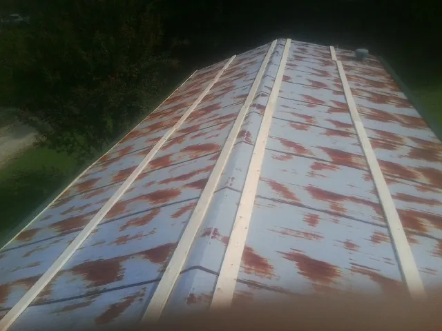 Rusted metal roof panels with new wood purlins before replacement — Storm Damage Roof Repair in Griffith by Roofing Brothers